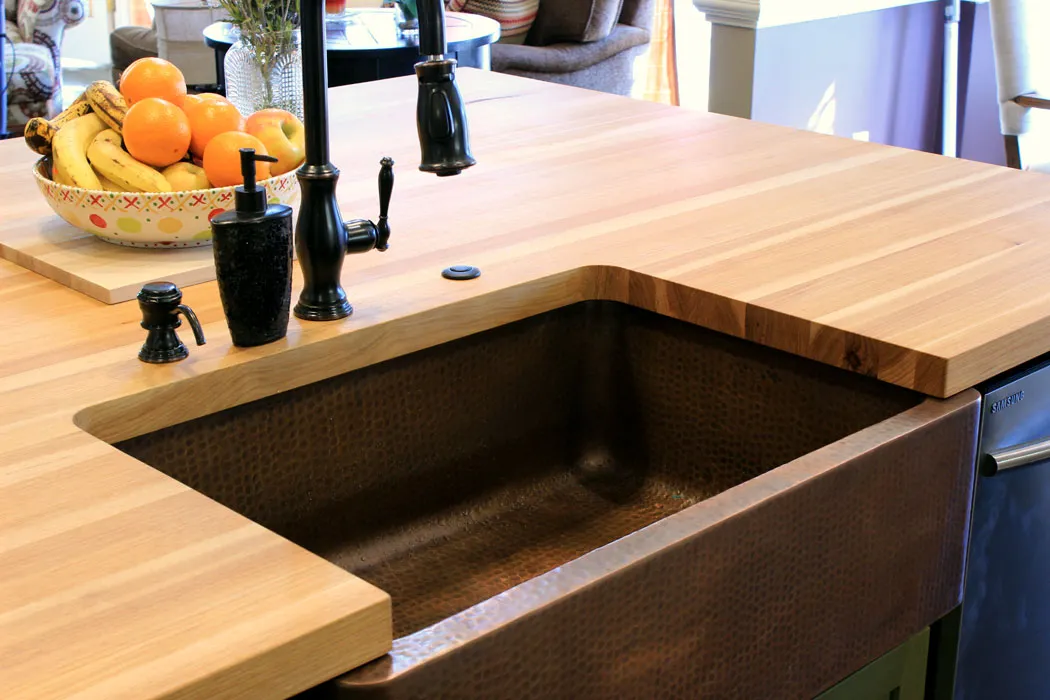 Custom hickory butcher block kitchen island with a farmhouse sink
