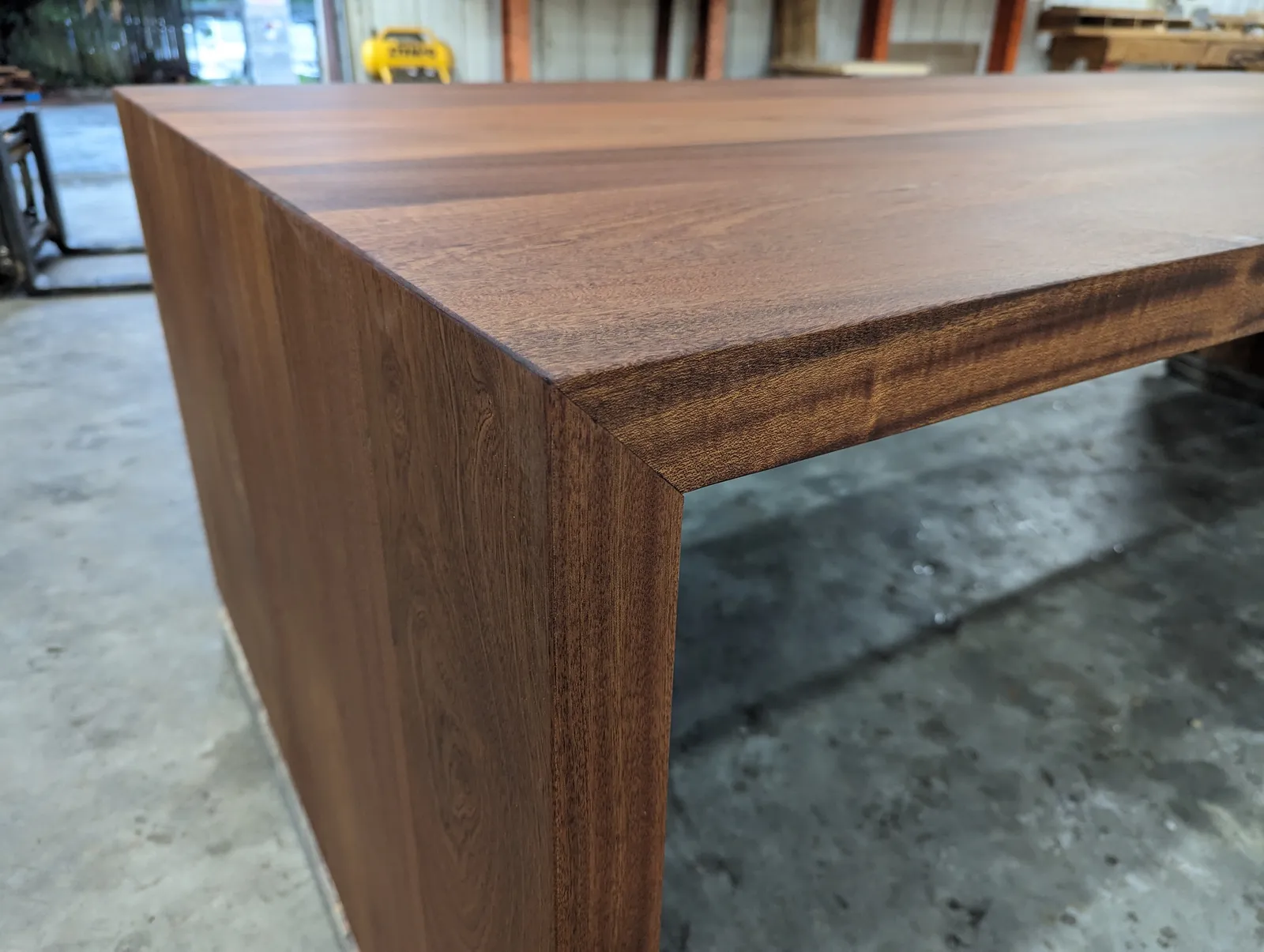 Custom sapele wood table with waterfall legs