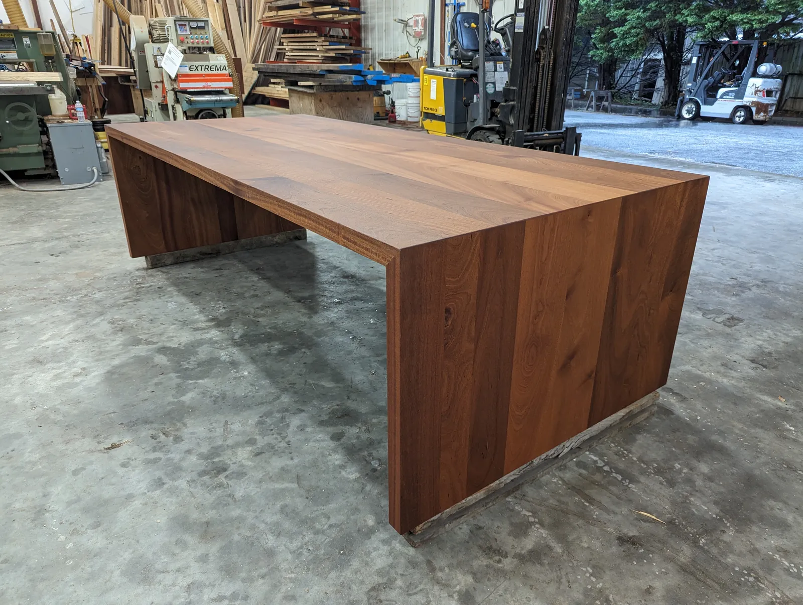 Custom sapele wood table with waterfall legs