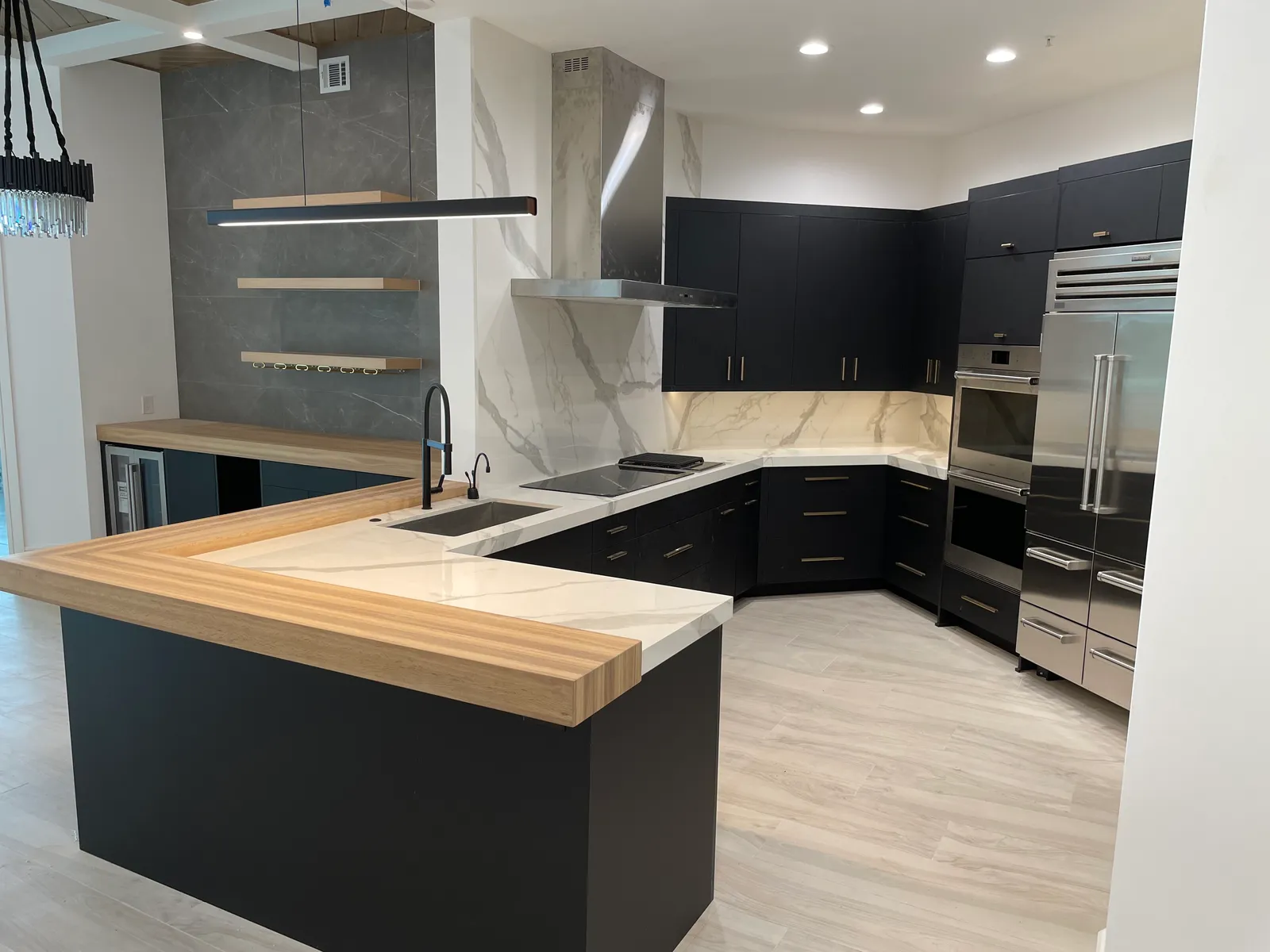 White oak bartop in a modern kitchen with black cabinets