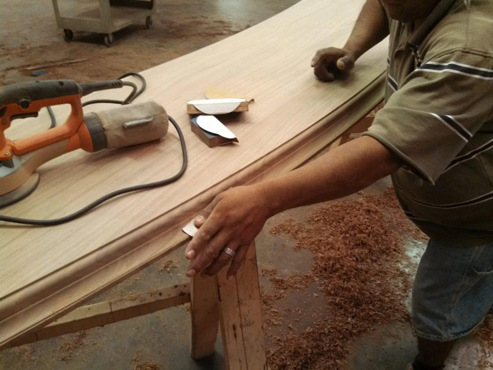 Wood bar top being hand sanded.