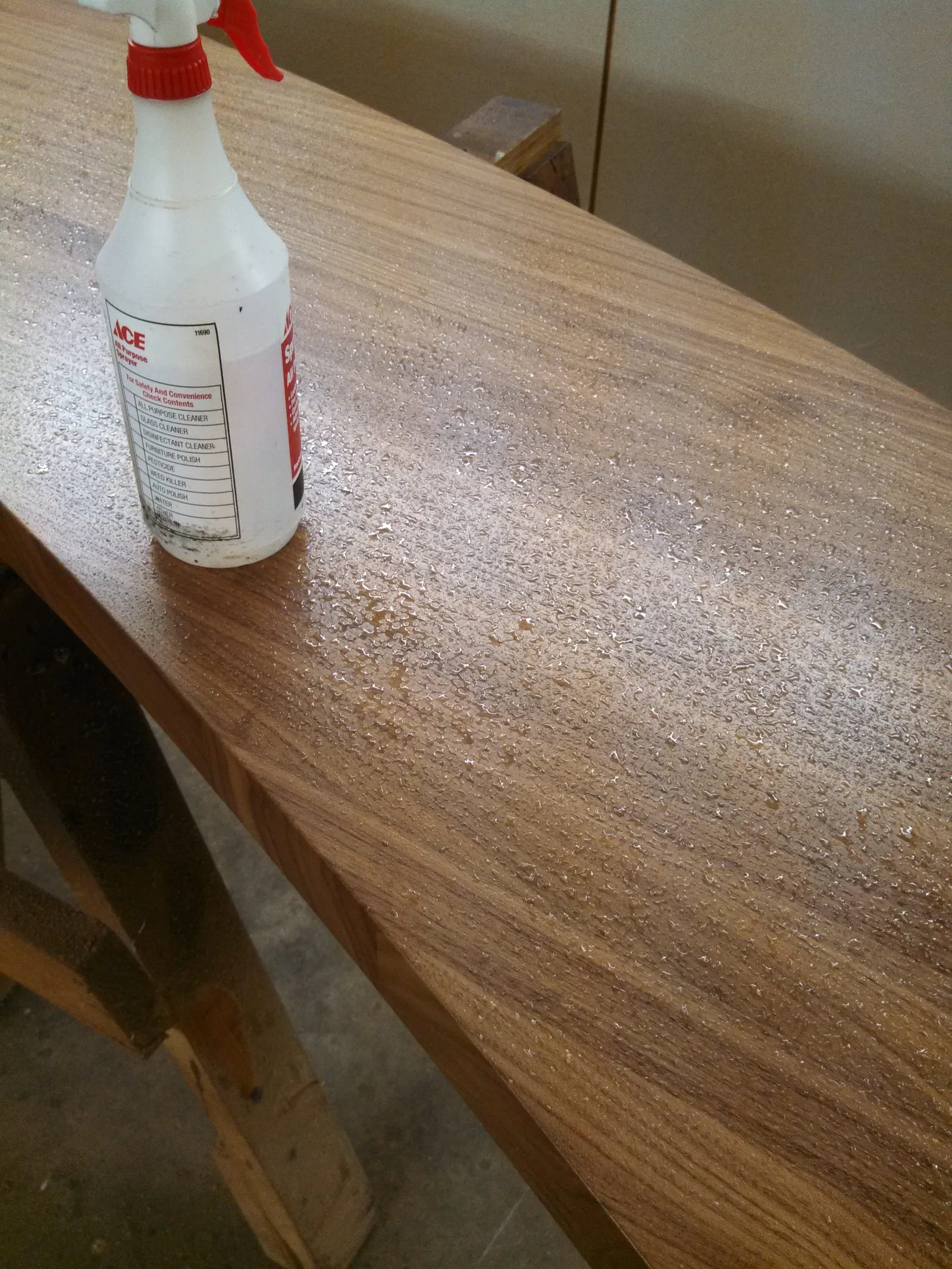 Wood bar top being wet sanded to give it a smooth texture.