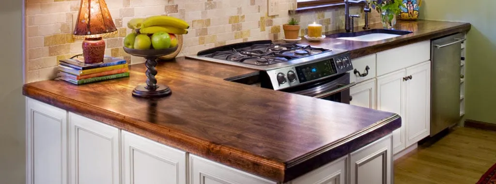 Distressed walnut countertops with gas range and undermount sink