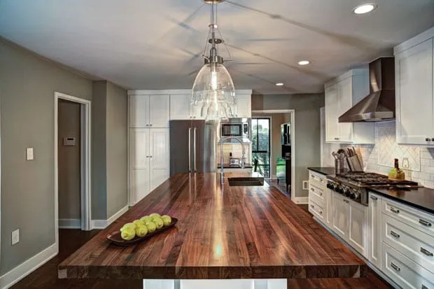 Walnut butcher block island in a modern kitchen design