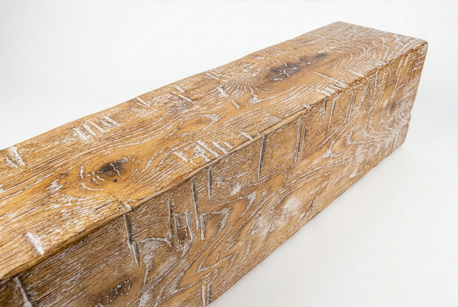 Hand-hewn white oak box beam with a limed finish, showing the hewn facets along its face